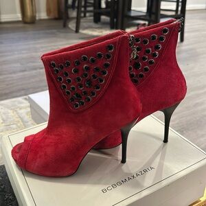Red suede studded open toe heels.